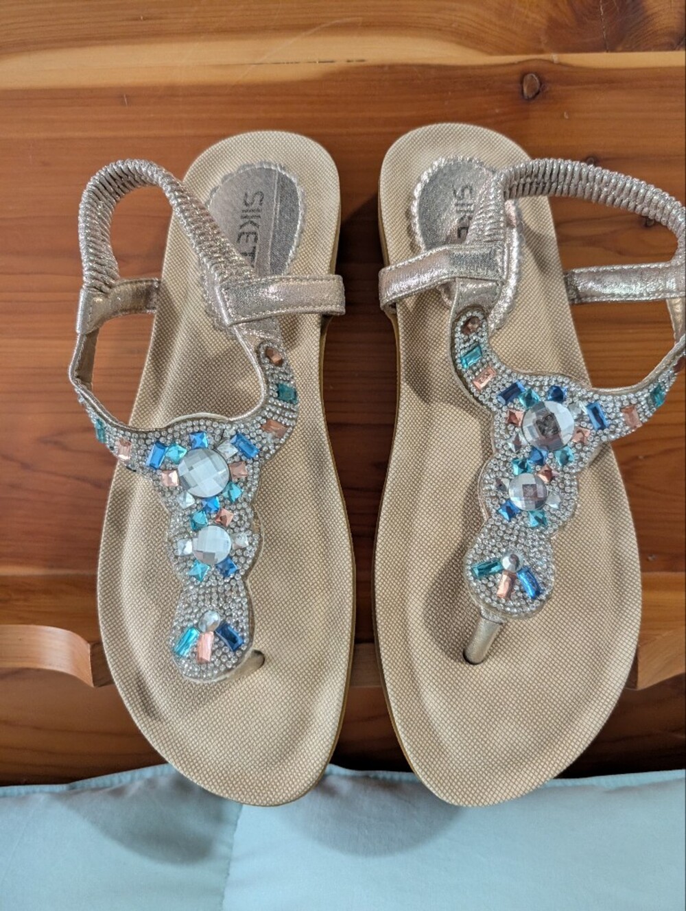 Metallic Gold T-Strap Sandals with Blue and Pink Gem Accents